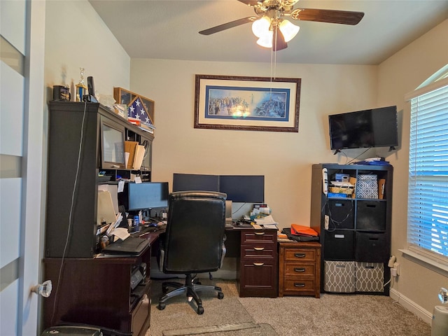 office featuring ceiling fan and light carpet