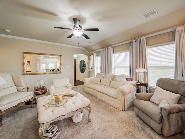 living room featuring carpet floors, ceiling fan, and ornamental molding