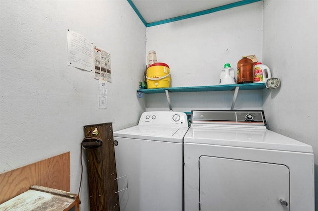 clothes washing area featuring washer and clothes dryer