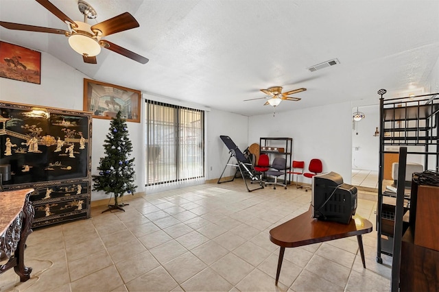 tiled living room with ceiling fan and lofted ceiling