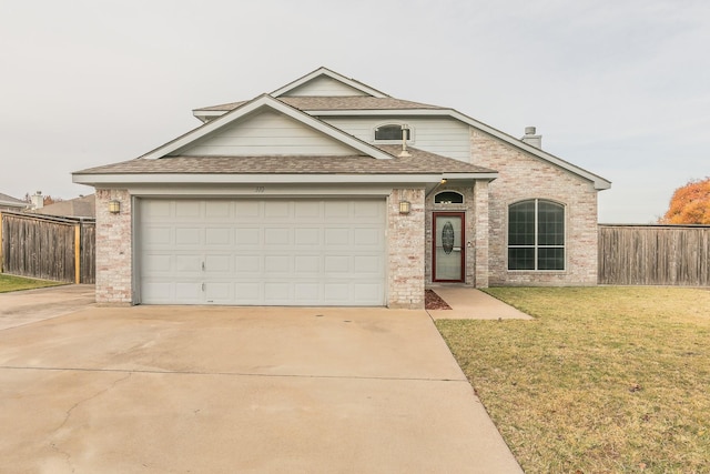 view of front of house with a garage and a front yard