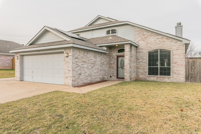 view of front of home featuring a front yard and a garage