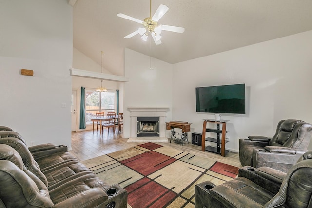 living room featuring light wood-type flooring, high vaulted ceiling, and ceiling fan