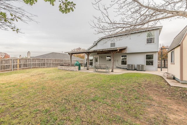 rear view of property with a patio, cooling unit, and a lawn