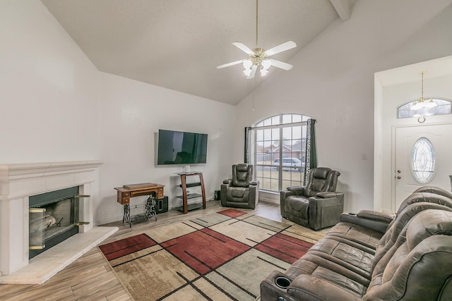 living room featuring ceiling fan, high vaulted ceiling, and light hardwood / wood-style floors