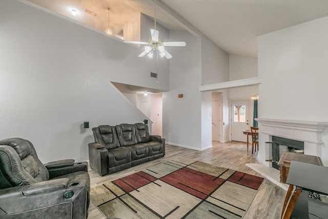 living room featuring ceiling fan, light hardwood / wood-style floors, and high vaulted ceiling