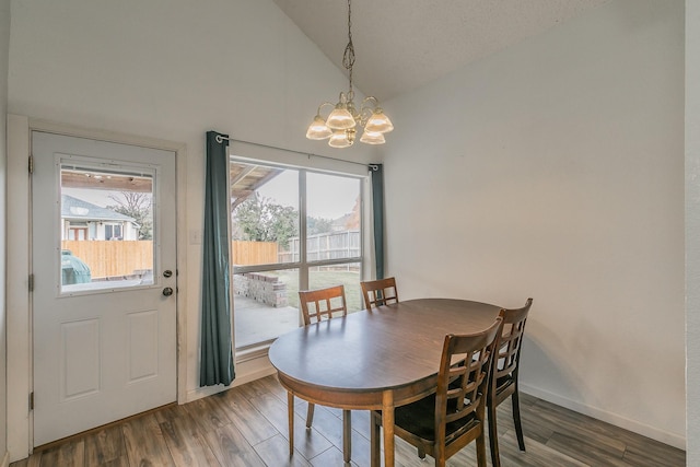 dining room featuring a chandelier, vaulted ceiling, and wood-type flooring