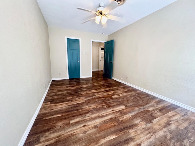 unfurnished bedroom with ceiling fan and dark hardwood / wood-style floors