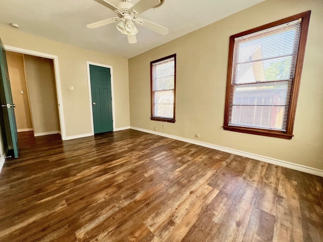 unfurnished bedroom featuring ceiling fan and dark hardwood / wood-style floors