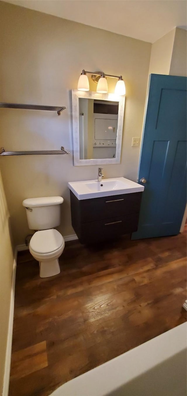 bathroom featuring hardwood / wood-style flooring, vanity, and toilet