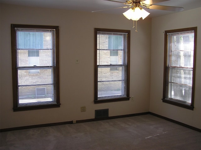 carpeted spare room with ceiling fan