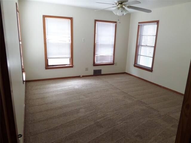 carpeted empty room with ceiling fan