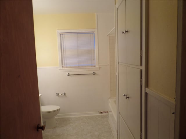 bathroom featuring shower with separate bathtub and toilet