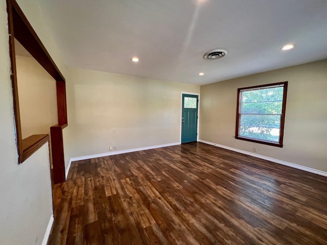 empty room with dark wood-type flooring