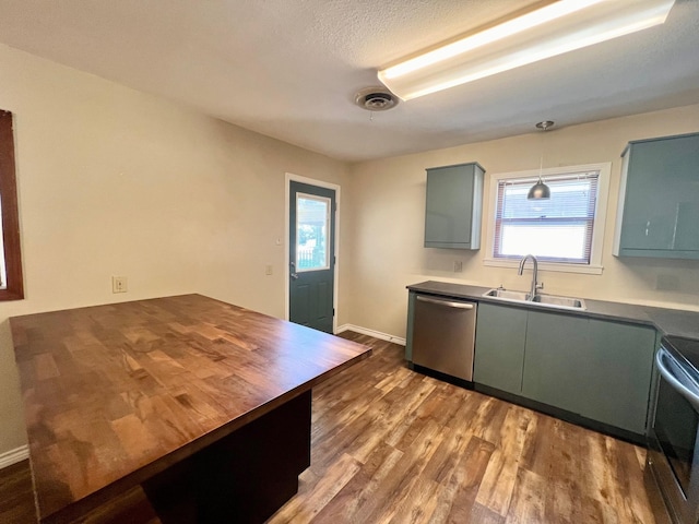 kitchen featuring dishwasher, sink, dark hardwood / wood-style floors, decorative light fixtures, and range