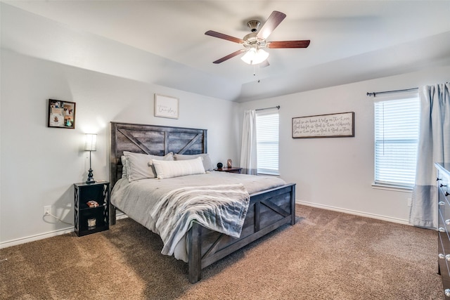 bedroom with dark colored carpet, ceiling fan, and lofted ceiling