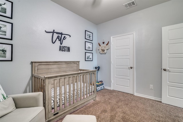 bedroom with carpet flooring and a nursery area