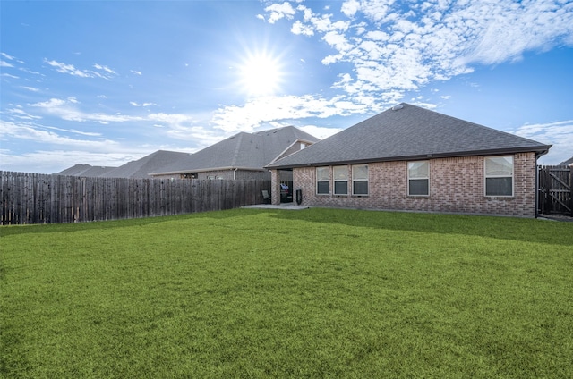 rear view of house featuring a lawn