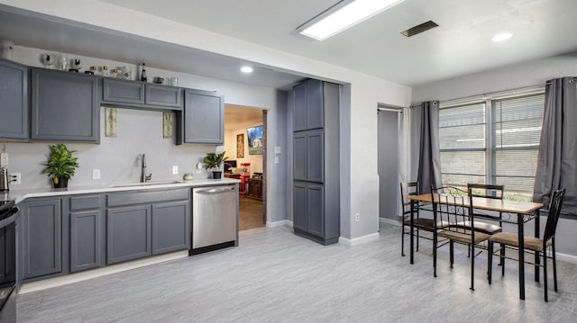 kitchen featuring stainless steel appliances, gray cabinets, light hardwood / wood-style floors, and sink