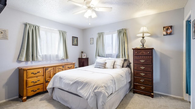 bedroom featuring ceiling fan, light carpet, and multiple windows