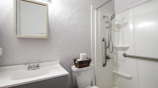 bathroom featuring toilet, vanity, and walk in shower