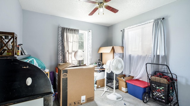 interior space featuring ceiling fan and a textured ceiling