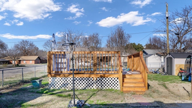 rear view of property featuring a wooden deck and a shed