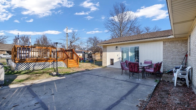 back of property with a patio and a deck