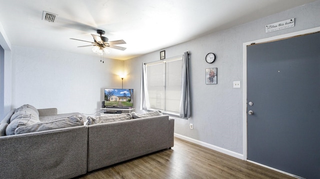 living room with ceiling fan and wood-type flooring