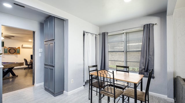 dining room featuring a wall mounted air conditioner, ceiling fan, and pool table