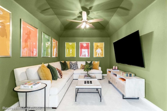 carpeted living room with ceiling fan and lofted ceiling