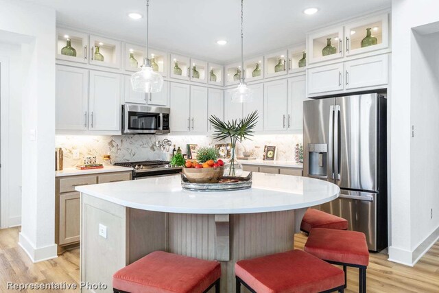 kitchen with appliances with stainless steel finishes, a center island, and white cabinetry