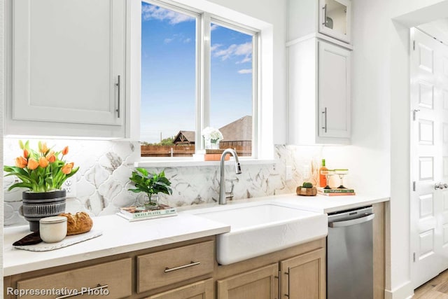 kitchen with decorative backsplash, white cabinets, sink, light brown cabinets, and dishwasher