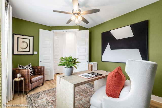 home office featuring light wood-type flooring and ceiling fan