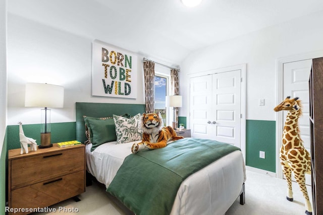 carpeted bedroom featuring vaulted ceiling