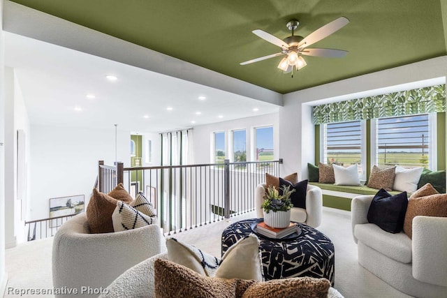 living room featuring carpet flooring and ceiling fan