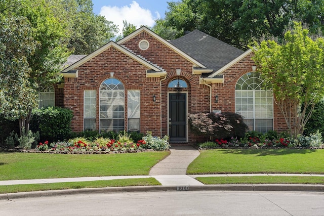 view of property featuring a front lawn