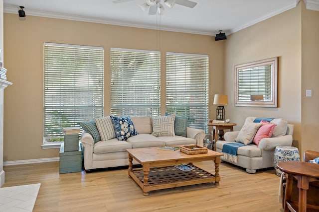 living room with light hardwood / wood-style floors, crown molding, and a wealth of natural light