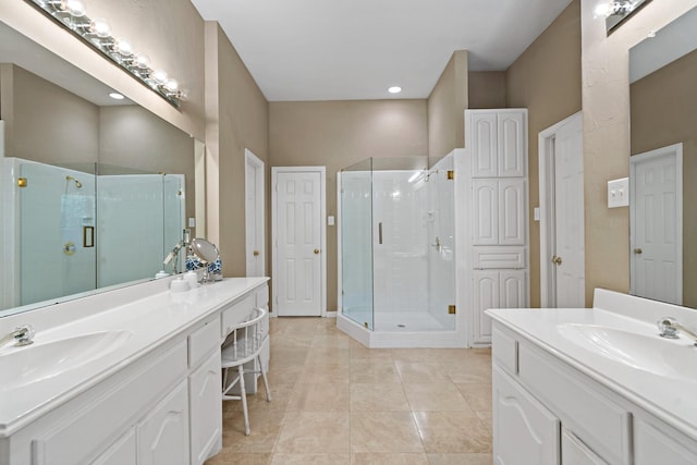 bathroom with tile patterned floors, vanity, and a shower with shower door