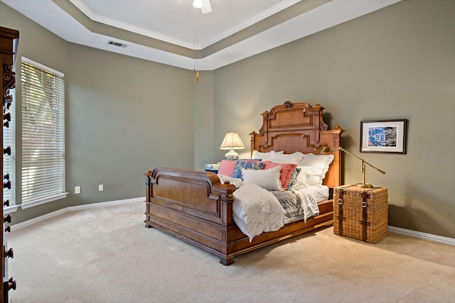 bedroom featuring a tray ceiling, ceiling fan, and carpet