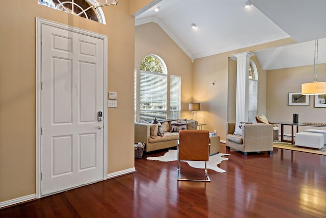 entryway with decorative columns, crown molding, dark hardwood / wood-style flooring, and high vaulted ceiling