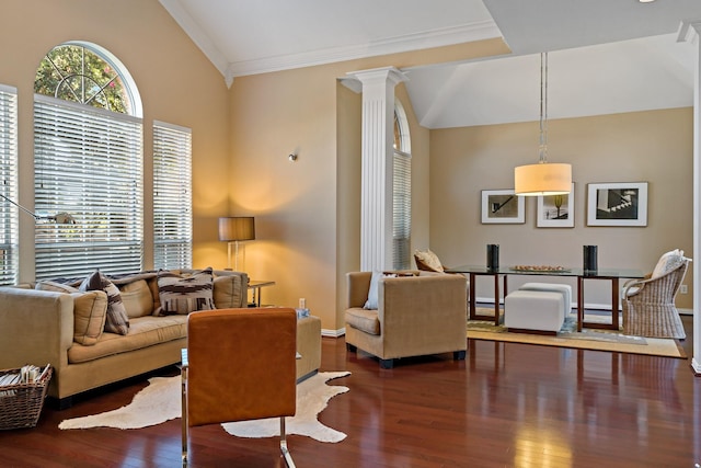 living room featuring vaulted ceiling, dark hardwood / wood-style floors, ornate columns, and ornamental molding