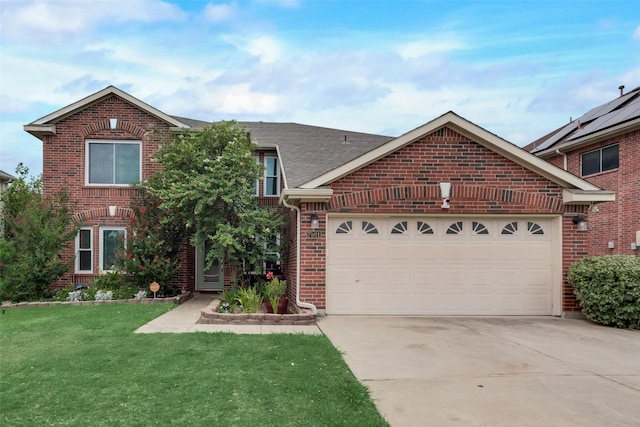 view of front property with a garage and a front lawn