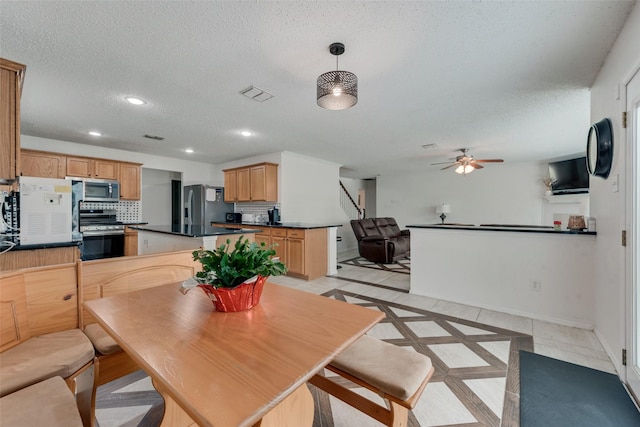 dining area featuring a textured ceiling