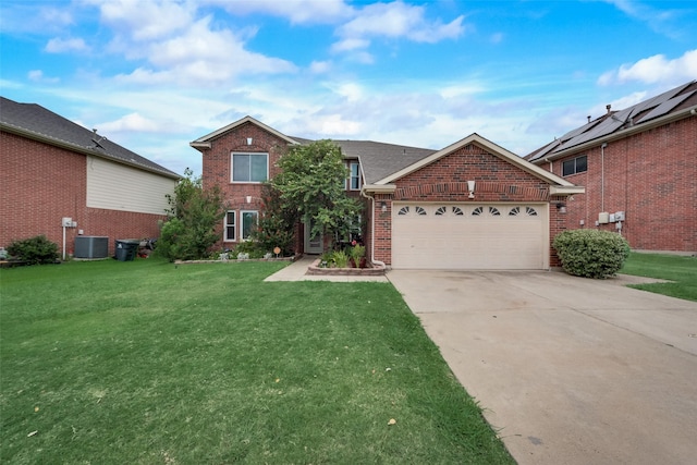 view of front of home featuring a garage, central AC, and a front yard