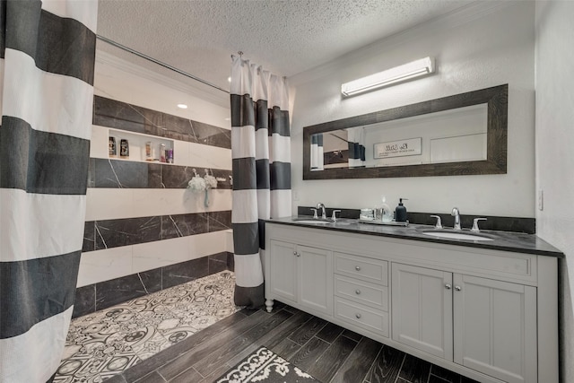 bathroom with vanity, ornamental molding, a textured ceiling, and a shower with shower curtain