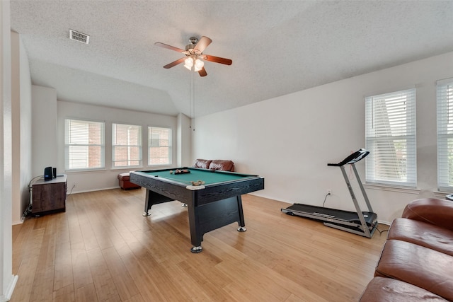 rec room featuring lofted ceiling, light hardwood / wood-style flooring, billiards, ceiling fan, and a textured ceiling