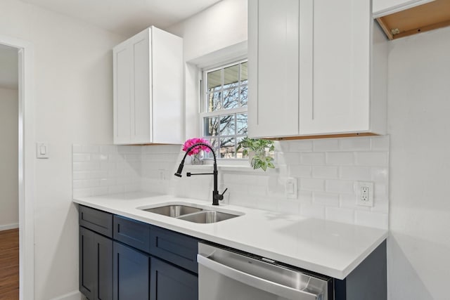 kitchen with dishwasher, backsplash, blue cabinetry, white cabinets, and sink