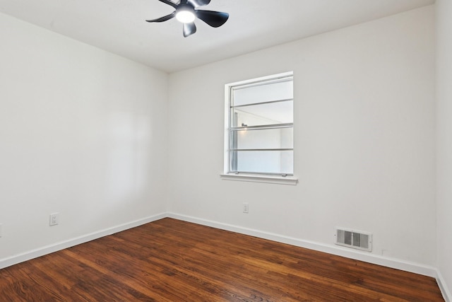 unfurnished room featuring ceiling fan and dark wood-type flooring