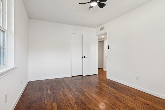 spare room featuring ceiling fan and dark hardwood / wood-style floors